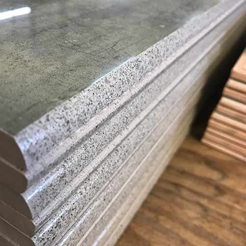 Image of speckled glaze technique on the bullnose edge of some high gloss bullnose tile pieces